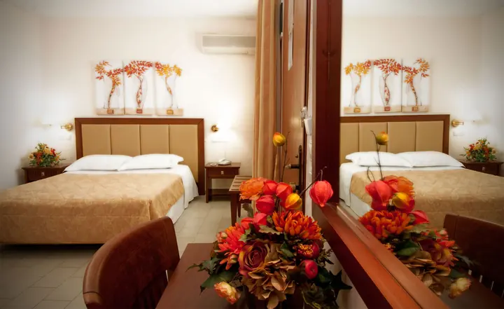 A bedroom with fresh flowers