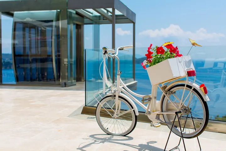 The white bicycle with flowers by the glass lift